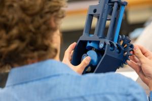 student examines a prototype
