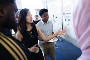 A student explains an element of a poster during the session