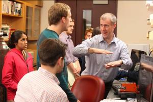 Prof. Brian Helmke works with students in a biomedical engineering teaching lab