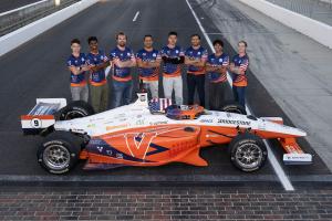 CAVCAR team with their vehicle on the Indianapolis Motor Speedway track.