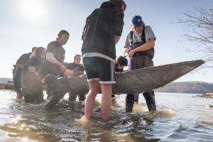 UVA Concrete Canoe Team members carrying a canoe