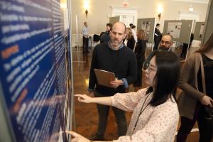Prof. Jonathan Goodall listens to a student during a poster session