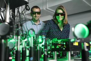 Prof. Patrick Hopkins works on a laser with a student