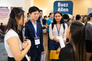Students speak with a recruiter during a career fair