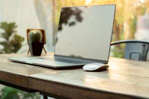 Laptop and mouse resting on tabletop