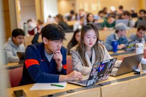 Two students work together on a project in class