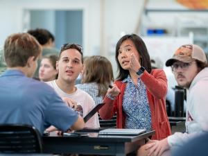 Professor Esther Tian explains something to a student