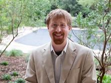 Man wearing beige jacket standing outside