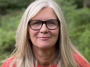 image of woman in red sweater with glasses