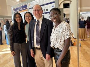 graduating fourth years in BME pose in front of a poster with Dr. Allen
