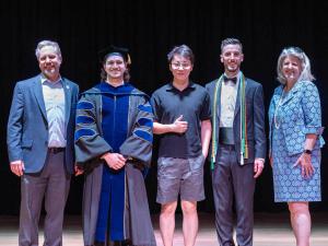 The Dean and the Associate Dean for Graduate Education and Post-Doctoral Affairs pose with three Outstanding Student Awardees