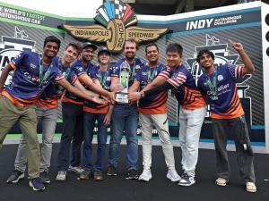 Team holding winning trophy