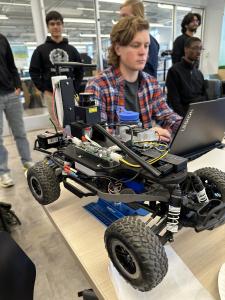A one-tenth scale autonomous race car being prepared for final race