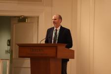 A man stands at a podium speaking