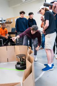 A student points out an aspect of the test run to teammates.