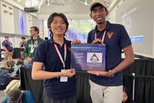 Two UVA students holding an award.