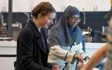 Closeup of two female students in food line