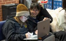 Two students looking at a computer