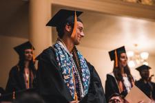 Students stand during the ceremony