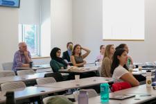 Students watch a final presentation