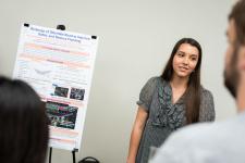 A student explains her poster