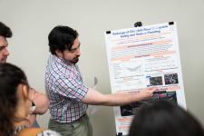 a student explains a feature on his poster