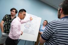 A student points out a feature of a poster