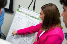 A student points out a feature of a poster