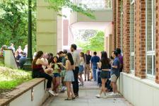 student and faculty eat at the picnic