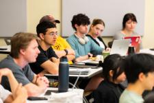 Students ask questions during a presentation