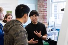 A student discusses a poster