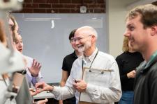 Faculty member discusses projects with students