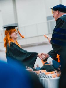 A student receives her diploma