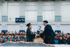 A student receives her diploma