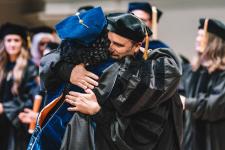 A student hugs a faculty member