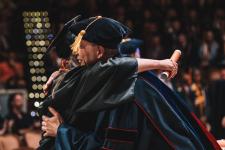 A student hugs a faculty member