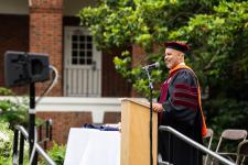 Chair Devin Harris speaks to the graduates