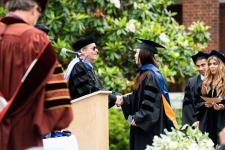 A student receives her diploma
