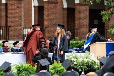 A student receives her diploma