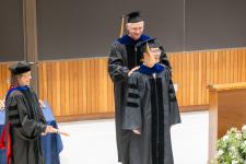 A Ph.D. graduate is hooded