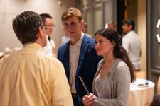 students talk to faculty at the dinner