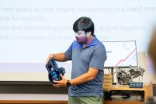 A student shows off a prototypr during a capstone presentation