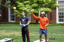 Students play cornhole during the picnic