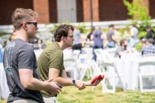 Students play cornhole during the picnic