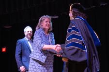 An award winner shakes Dean West's hand