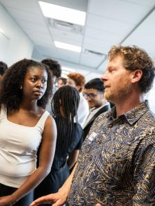 Students and faculty talk at the expo
