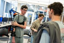 Student displays a mechanical exoskeleton
