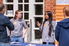 Chemical engineering students speak with attendees