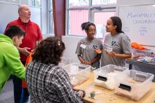 First-year engineering students speak with attendees