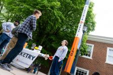 Rocketry team members speak to attendees